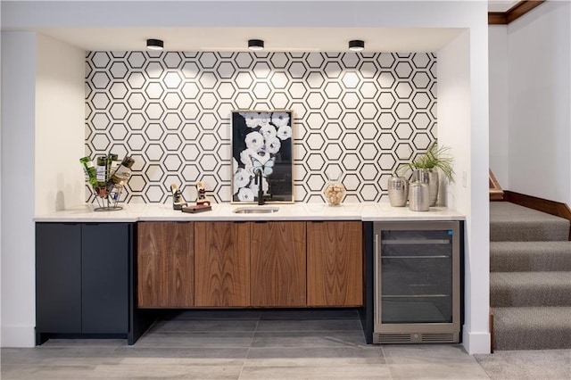 2150 Palisades Dr, Riverside, MO 64150 - bar featuring backsplash, wine cooler, and sink