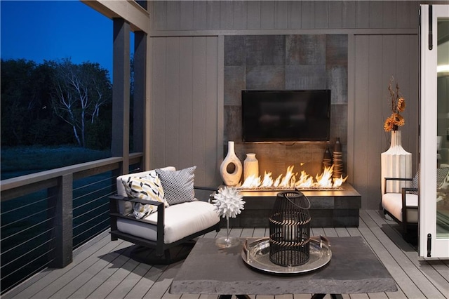 2150 Palisades Dr, Riverside, MO 64150 - deck at twilight featuring exterior fireplace