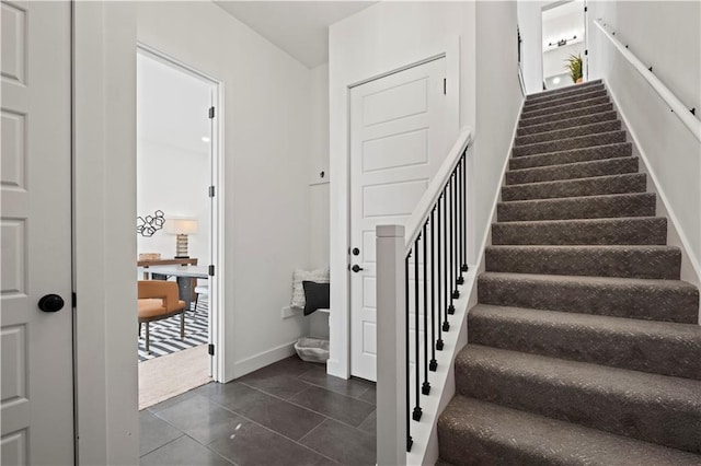 stairway with tile patterned flooring