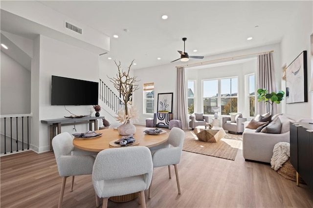 dining area featuring light wood-type flooring and ceiling fan