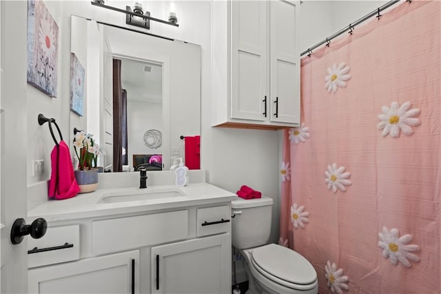 bathroom with vanity, a shower with shower curtain, and toilet