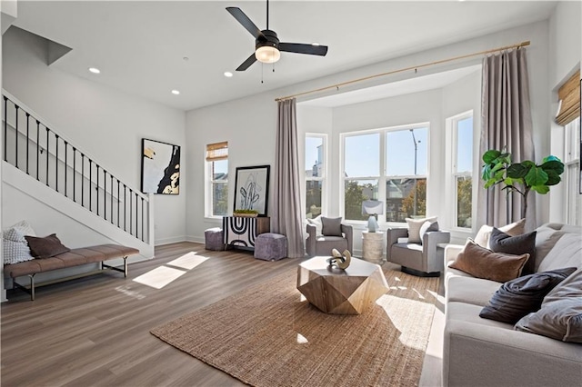 living room with wood-type flooring and ceiling fan