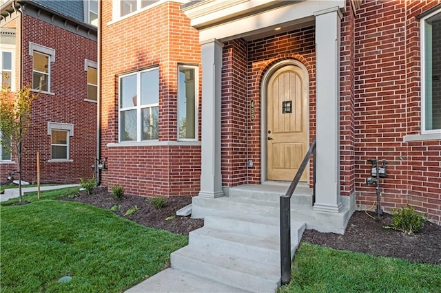 entrance to property featuring a lawn