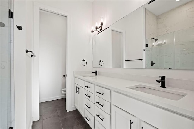 bathroom featuring vanity, tile patterned floors, toilet, and an enclosed shower