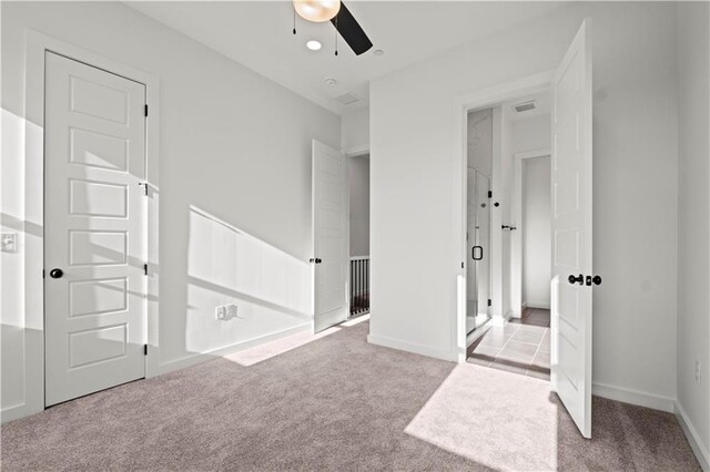 unfurnished bedroom featuring light colored carpet and ceiling fan