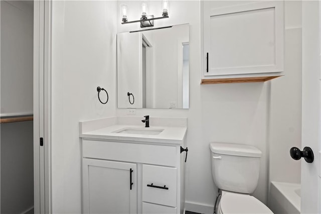 full bathroom with toilet, plus walk in shower, and vanity