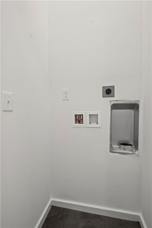 laundry area featuring hookup for an electric dryer, washer hookup, and dark tile patterned flooring