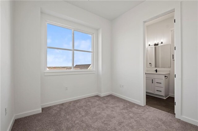 451 SW Longview Blvd, Lees Summit, MO 64081 - unfurnished bedroom with dark carpet, baseboards, and connected bathroom