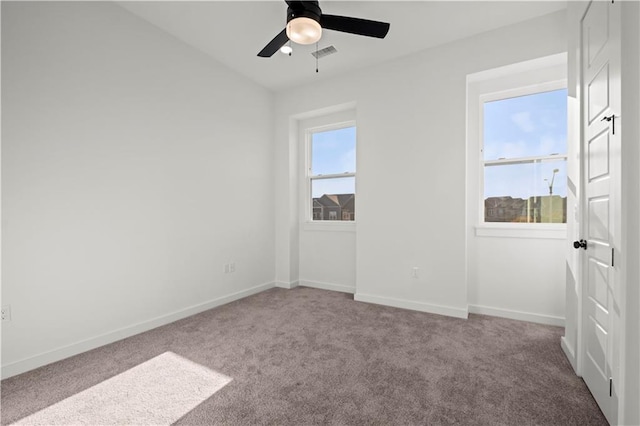 empty room featuring carpet flooring and ceiling fan