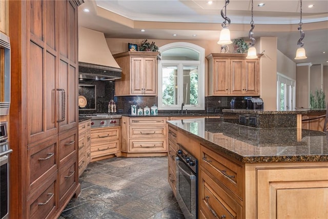 1709 Lake Alvamar Dr, Lawrence, KS 66047 - kitchen with premium range hood, a sink, stainless steel appliances, decorative backsplash, and stone finish flooring
