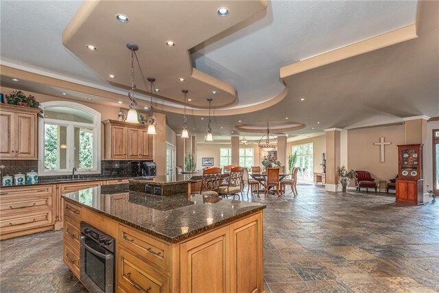 1709 Lake Alvamar Dr, Lawrence, KS 66047 - kitchen featuring a sink, a tray ceiling, oven, stone tile flooring, and recessed lighting