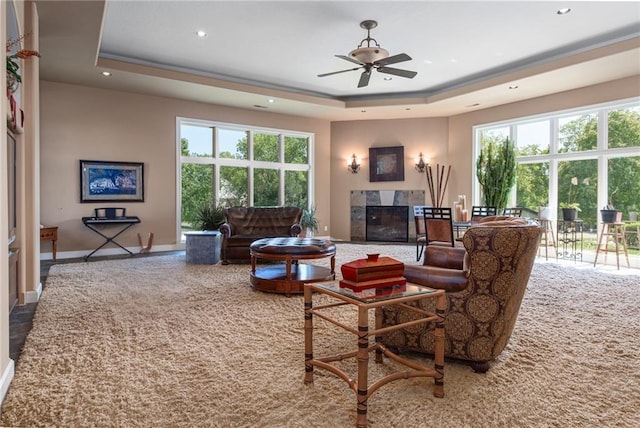 1709 Lake Alvamar Dr, Lawrence, KS 66047 - living area featuring a tray ceiling, recessed lighting, a tiled fireplace, and carpet floors