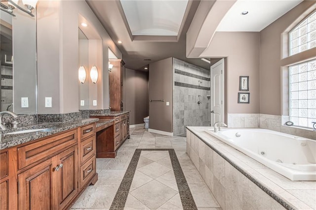 1709 Lake Alvamar Dr, Lawrence, KS 66047 - full bath with a whirlpool tub, toilet, baseboards, tiled shower, and vanity