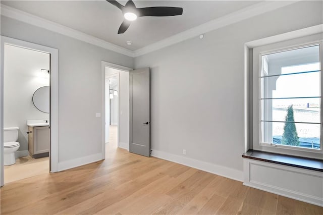 unfurnished bedroom featuring ceiling fan, ornamental molding, light hardwood / wood-style flooring, and ensuite bath