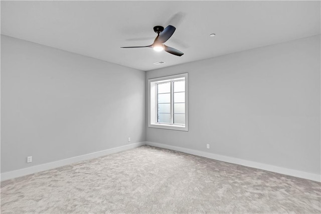 carpeted spare room featuring ceiling fan