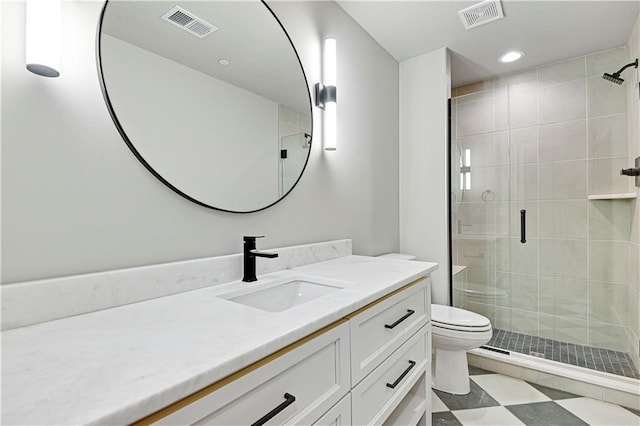 bathroom featuring vanity, toilet, and a shower with shower door