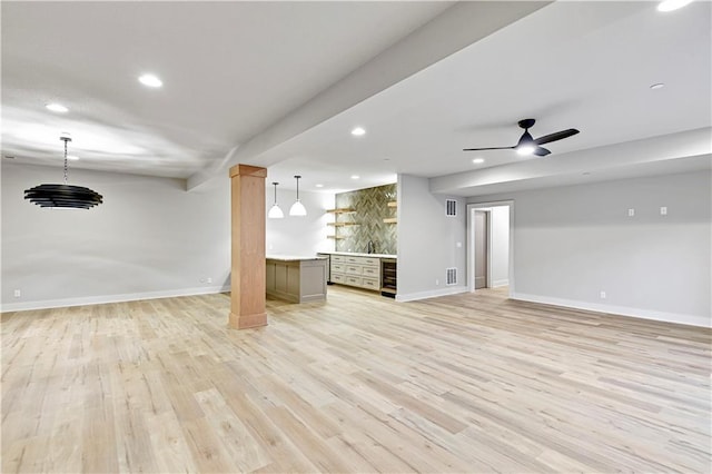 unfurnished living room featuring light wood-type flooring, wine cooler, and ceiling fan