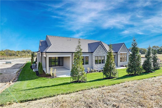 rear view of property with a lawn