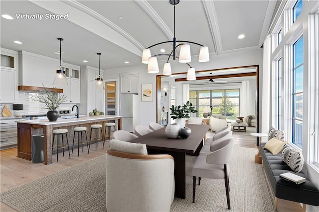 dining room with recessed lighting, beam ceiling, and light wood finished floors