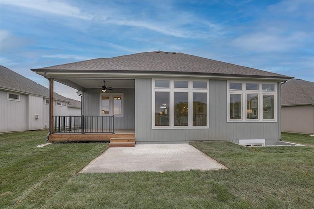12200 W 138th Pl, Overland Park, KS 66221 - rear view of property with a ceiling fan, a lawn, a patio, and a shingled roof