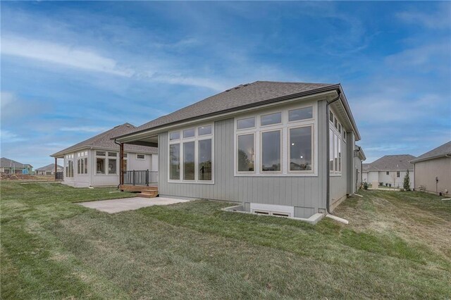 12200 W 138th Pl, Overland Park, KS 66221 - rear view of property with a patio area, a yard, and a shingled roof