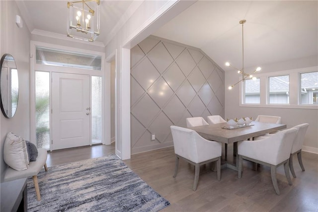 12200 W 138th Pl, Overland Park, KS 66221 - dining space with a chandelier, baseboards, a decorative wall, wood finished floors, and an accent wall