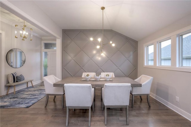 12200 W 138th Pl, Overland Park, KS 66221 - dining area with a chandelier, baseboards, an accent wall, wood finished floors, and a decorative wall