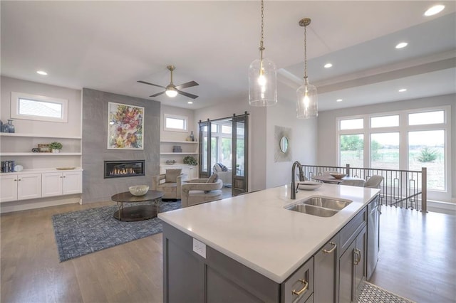 12200 W 138th Pl, Overland Park, KS 66221 - kitchen featuring a sink, wood finished floors, recessed lighting, light countertops, and healthy amount of natural light