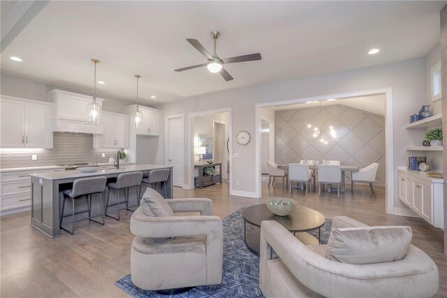 12200 W 138th Pl, Overland Park, KS 66221 - living area featuring light wood-style flooring, ceiling fan, recessed lighting, and baseboards
