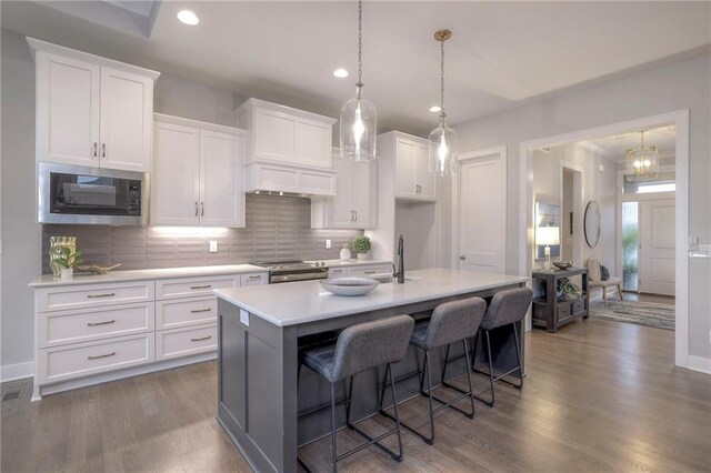 12200 W 138th Pl, Overland Park, KS 66221 - kitchen featuring stainless steel range with gas stovetop, light countertops, white cabinetry, tasteful backsplash, and recessed lighting