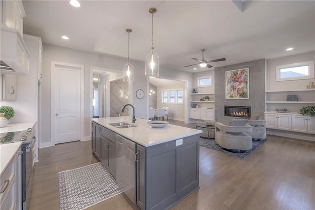 12200 W 138th Pl, Overland Park, KS 66221 - kitchen with a sink, appliances with stainless steel finishes, a ceiling fan, a fireplace, and light countertops