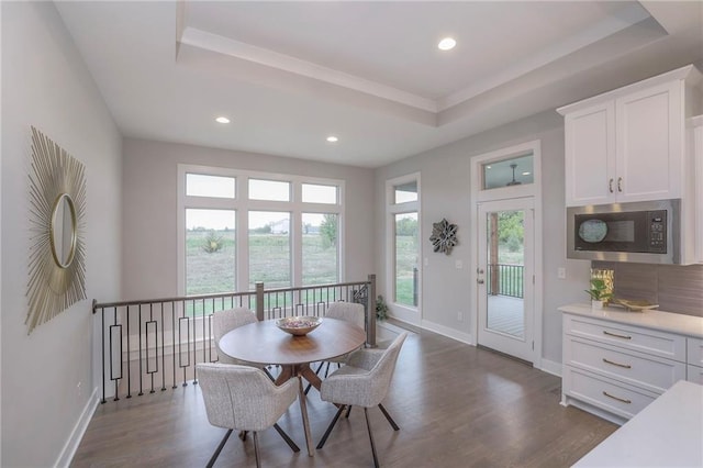 12200 W 138th Pl, Overland Park, KS 66221 - dining area featuring a tray ceiling, dark wood-style floors, baseboards, and recessed lighting