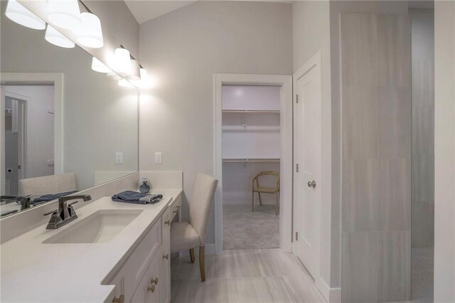 12200 W 138th Pl, Overland Park, KS 66221 - bathroom featuring vanity, a spacious closet, and baseboards
