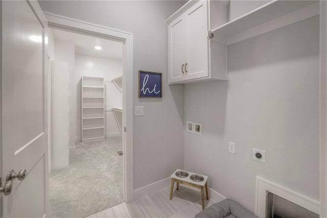 12200 W 138th Pl, Overland Park, KS 66221 - laundry area with cabinet space, hookup for an electric dryer, hookup for a washing machine, light colored carpet, and baseboards