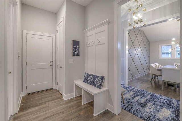 12200 W 138th Pl, Overland Park, KS 66221 - mudroom featuring a chandelier, wood finished floors, and baseboards