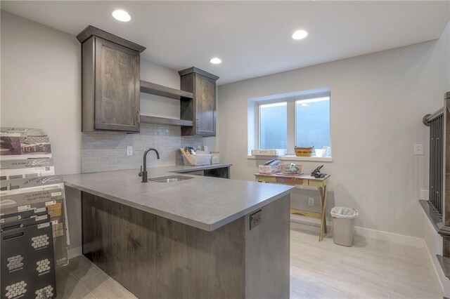 12200 W 138th Pl, Overland Park, KS 66221 - kitchen with a sink, open shelves, tasteful backsplash, a peninsula, and dark brown cabinets