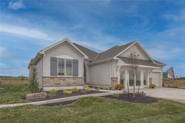 13812 Quigley St, Overland Park, KS 66221 - view of front facade with stucco siding, stone siding, concrete driveway, and a garage