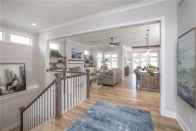13812 Quigley St, Overland Park, KS 66221 - hall with wood finished floors, healthy amount of natural light, baseboards, ornamental molding, and recessed lighting