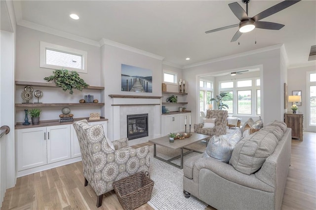 13812 Quigley St, Overland Park, KS 66221 - living room with a ceiling fan, ornamental molding, light wood-type flooring, a glass covered fireplace, and recessed lighting