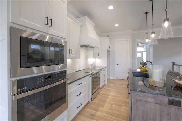 13812 Quigley St, Overland Park, KS 66221 - kitchen featuring stainless steel appliances, premium range hood, a sink, ornamental molding, and dark stone countertops