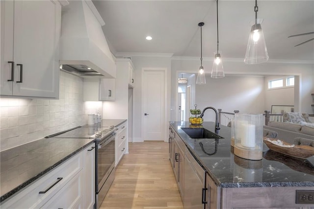 13812 Quigley St, Overland Park, KS 66221 - kitchen featuring premium range hood, a sink, stainless steel electric stove, crown molding, and a kitchen island with sink