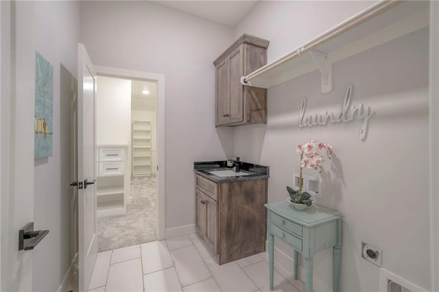 13812 Quigley St, Overland Park, KS 66221 - laundry room featuring hookup for an electric dryer, cabinet space, baseboards, and light colored carpet
