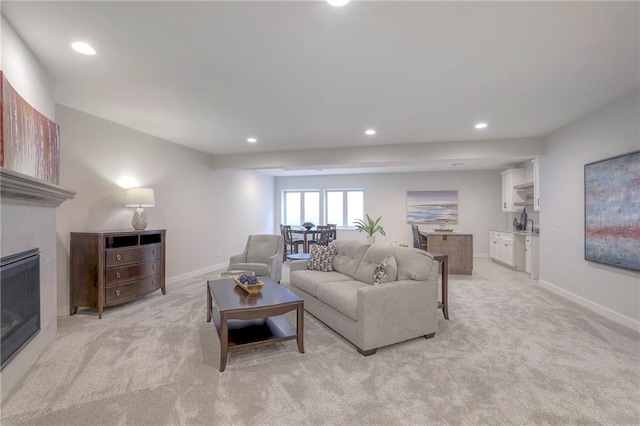 13812 Quigley St, Overland Park, KS 66221 - living room featuring recessed lighting, light carpet, a glass covered fireplace, and baseboards