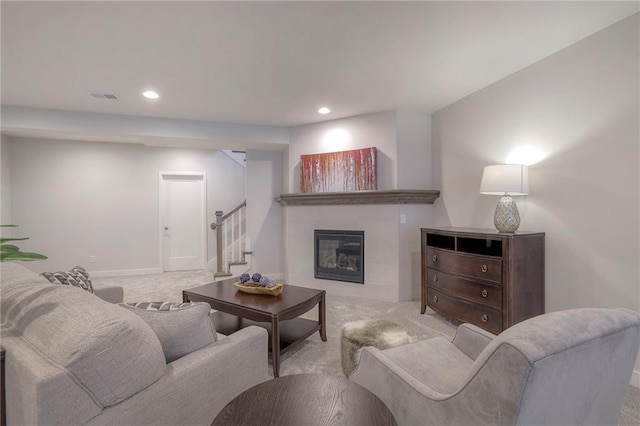 13812 Quigley St, Overland Park, KS 66221 - living area with carpet floors, stairway, recessed lighting, a tile fireplace, and baseboards