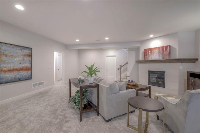 13812 Quigley St, Overland Park, KS 66221 - living area featuring stairway, recessed lighting, a tile fireplace, light colored carpet, and baseboards