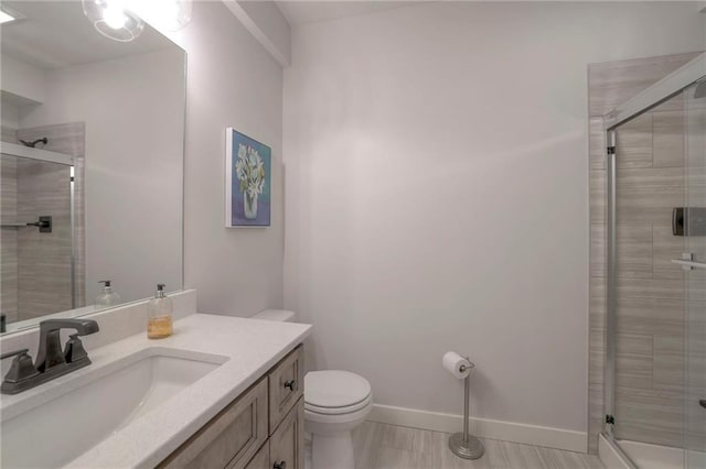 13812 Quigley St, Overland Park, KS 66221 - full bathroom with vanity, toilet, a stall shower, and baseboards
