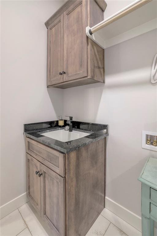 13812 Quigley St, Overland Park, KS 66221 - laundry room featuring hookup for a washing machine, cabinet space, baseboards, and light tile patterned flooring