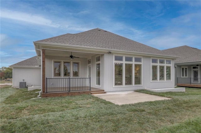 13812 Quigley St, Overland Park, KS 66221 - back of house featuring a ceiling fan, a shingled roof, a lawn, a patio area, and central AC