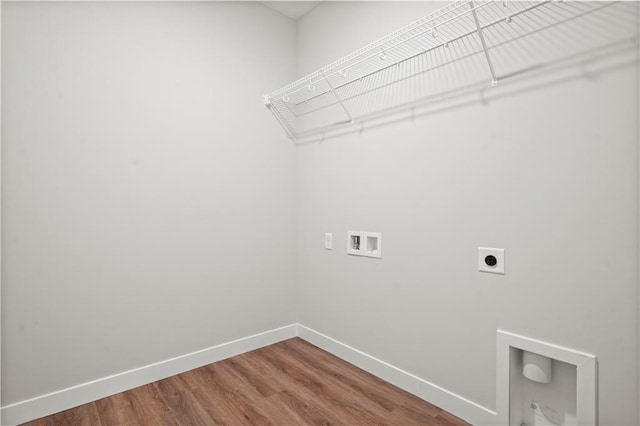 laundry room featuring hookup for a washing machine, hookup for an electric dryer, wood finished floors, laundry area, and baseboards