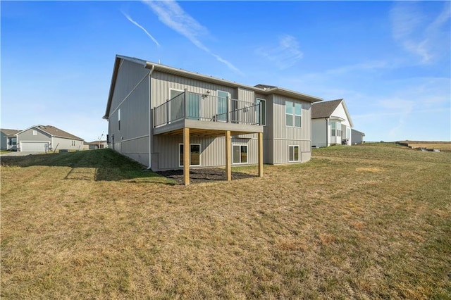 rear view of property featuring a lawn